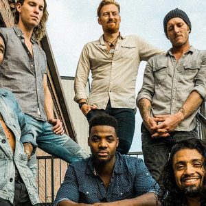 Nahko and Medicine For the People poses on outside stairs